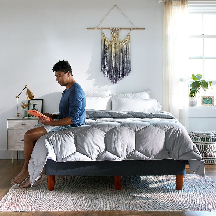 Man site on comforter